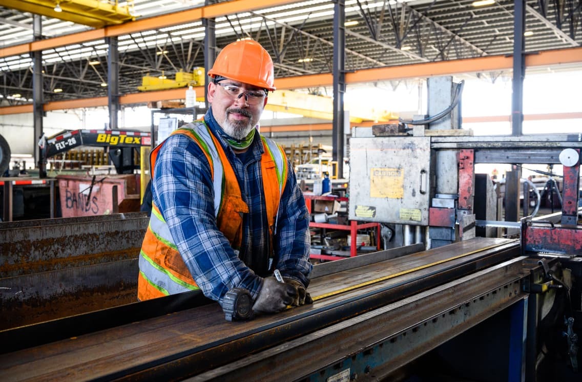 worker standing next to steel 